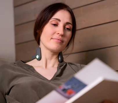 Woman wearing Pulsetto while reading
